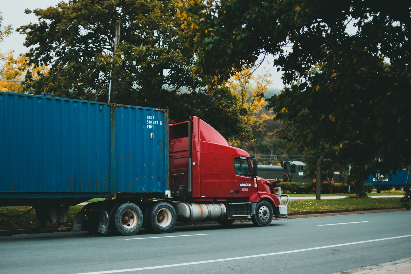 Red semi-truck hauling a freight container
